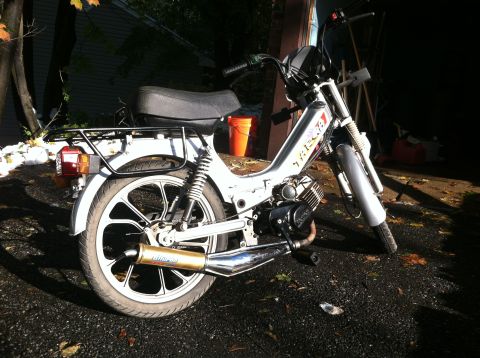 1999 Tomos Targa - A silver moped with a black seat and rear rack is parked outdoors.