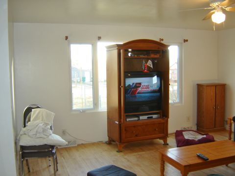 1984 Ford Mustang - Interior view of a living room a television set within a wooden cabinet and a coffee table in the foreground.