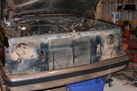 1989 Ford Bronco - The front of a 1989 Ford Bronco is shown with its hood open, revealing the engine and radiator area.