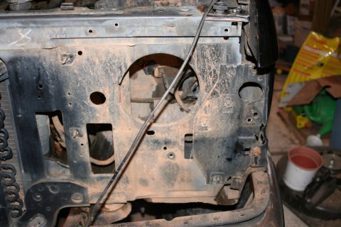 1989 Ford Bronco - This image shows the front section of a vehicle's frame and engine bay, with visible dirt and some wiring.