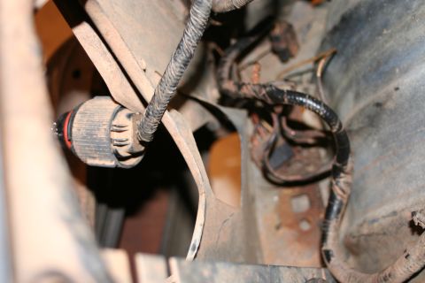 1989 Ford Bronco - Close-up of an electrical connector and wiring harness, showing dirt and rust.