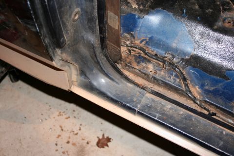 1989 Ford Bronco - Door sill area shows significant rust and damage, with wiring exposed.