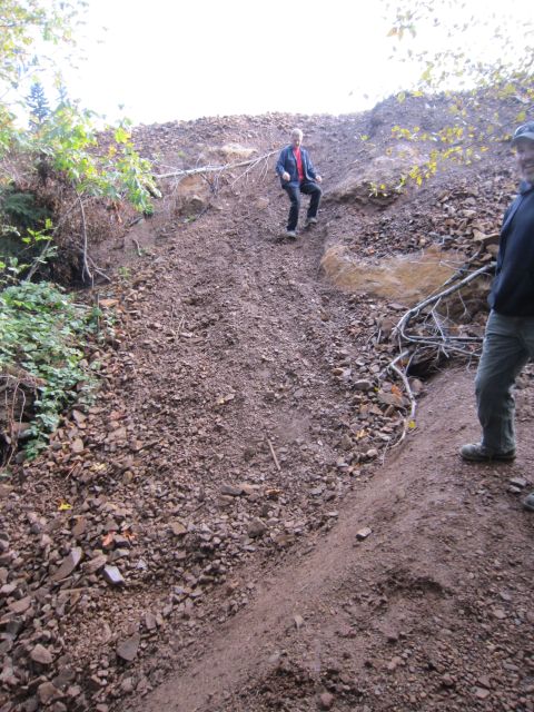 2008 Jeep Wrangler - Two people navigate a steep, rocky slope in an outdoor natural setting.