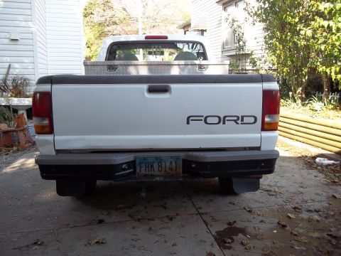 1970 Ford Ranchero - This white Ford pickup truck is viewed from the rear, showing its tailgate and bumper.