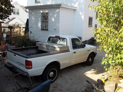 1970 Ford Ranchero - A white Ford Ranger pickup truck is parked in a driveway next to a white house.