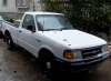 1970 Ford Ranchero - A white Ford Ranger pickup truck is parked outside on a wet day.