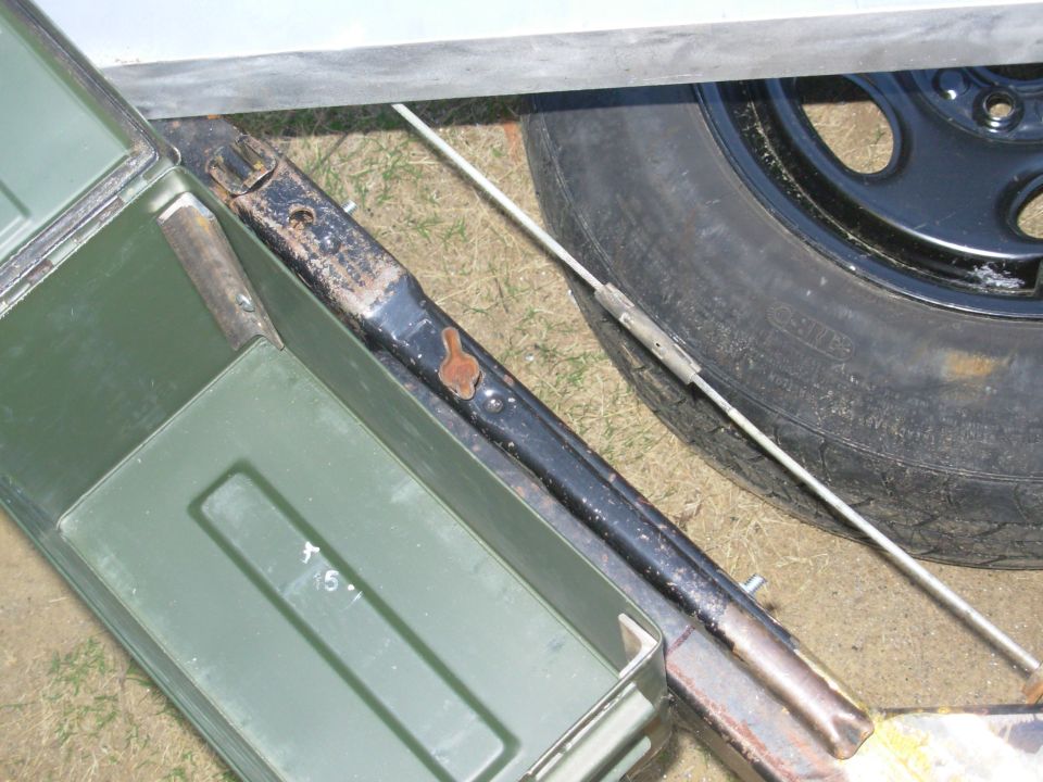 The ammo can will hold straps, spare lug nuts, tire chocks (etc.), and the lug wrench stows neatly beside it.  Everything will be hidden & secured by the locking pin in the tilt catch.