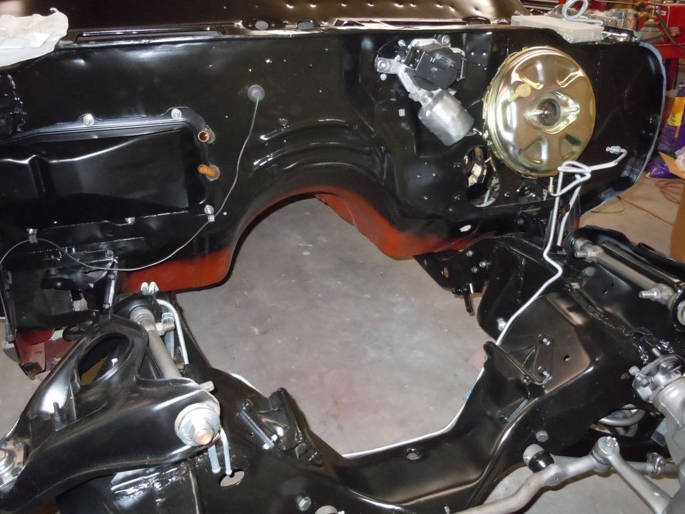 Car's engine bay frame with brake booster and master cylinder visible