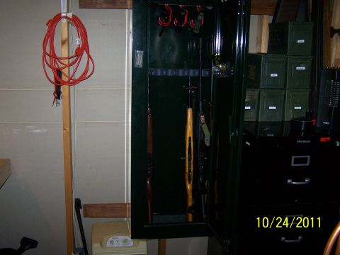1989 Ford Bronco - Interior of a gun safe with firearms and ammunition cans visible, dated 10/24/2011.