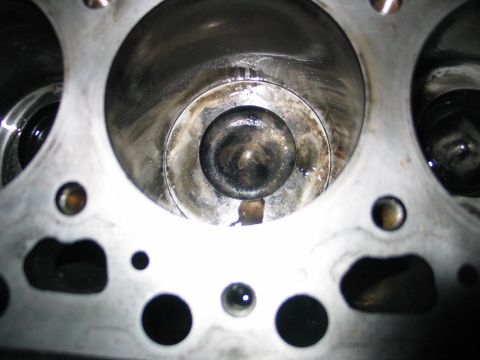 1984 Ford Bronco - Close-up view of an engine cylinder, showing internal components and some wear.