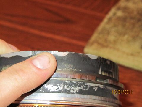 1984 Ford Bronco - A damaged piston ring shows wear and chipping along its edge.