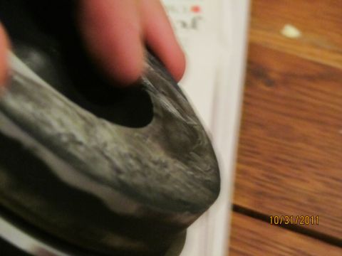 1984 Ford Bronco - A close-up view of a worn vehicle part, with text and a date visible in the background.