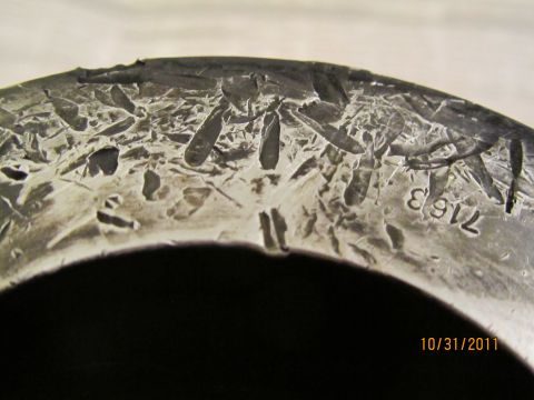 1984 Ford Bronco - Stamped numbers on a vehicle part, possibly a casting mark or serial number.