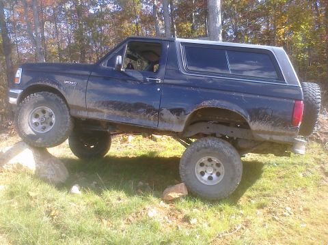 1995 Ford Bronco - This 1995 Ford Bronco is shown navigating an off-road obstacle course with its tires on rocks.