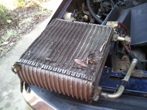 1994 Ford Bronco - The AC condenser unit is shown removed from the vehicle, revealing its internal fins and external connections.