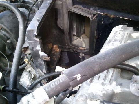 1994 Ford Bronco - Close-up of an AC system component in an engine bay, a cracked hose with 'COOL' visible.