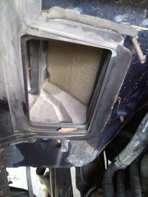 1994 Ford Bronco - The AC system's filter housing is visible, with some debris inside the duct.