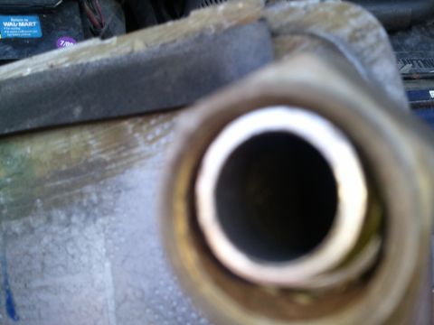 1994 Ford Bronco - Radiator hose connection detail, with a Wal-Mart battery visible in the background.