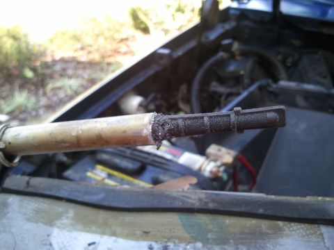 1994 Ford Bronco - The oil dipstick appears to be heavily soiled and possibly damaged.