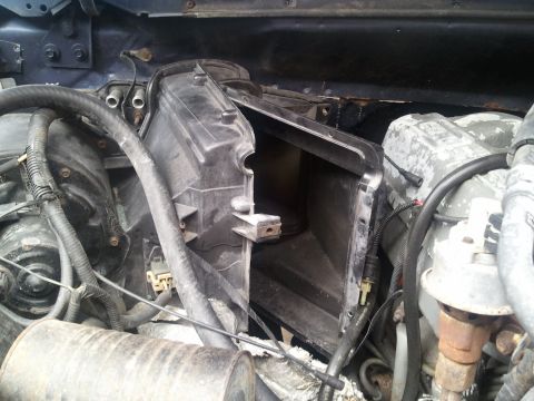 1994 Ford Bronco - Close-up view of the AC system housing within the engine compartment, showing various hoses and electrical connections.