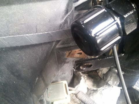 1994 Ford Bronco - A close-up view of a component within the AC system, showing a black, ribbed cap and metal bracketry.