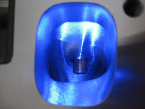 1972 Ford Ranchero - A close-up view of an engine intake port illuminated with blue light, showing machined surfaces.