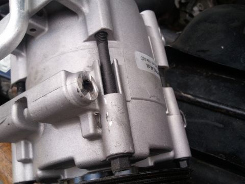1994 Ford Bronco - Close-up view of an AC compressor, showing a label with some readable text.