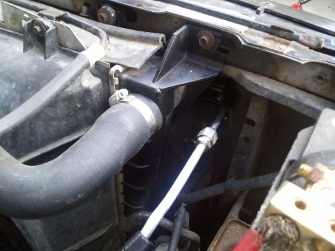 1994 Ford Bronco - The photo shows a section of the engine bay, focusing on hoses and the radiator support structure.