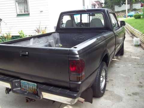 1970 Ford Ranchero - This black Ford pickup truck is seen from the rear, displaying the license plate FHK 8141.