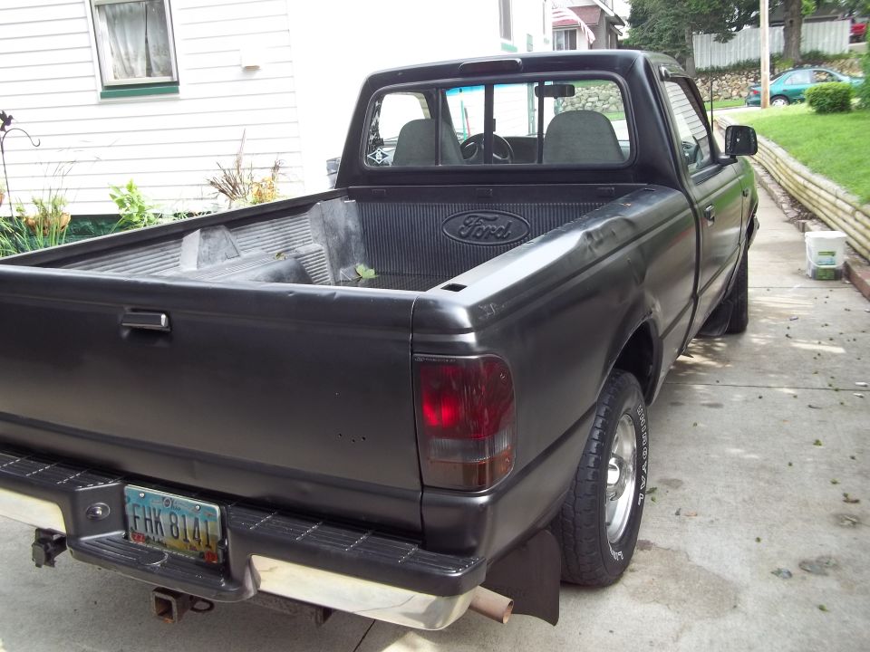 Black Ford pickup truck rear view with license plate FHK 8141