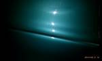 1994 Ford Probe - Abstract teal and black scene with bright light streaks.