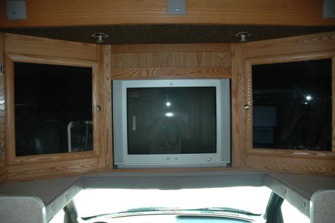 2005 Chevrolet C-6500/Kodiak - Interior view of an RV showing a television mounted above the dashboard.