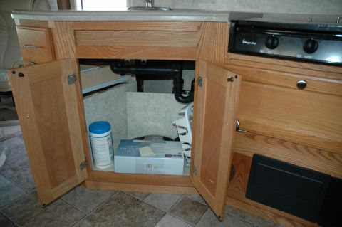 2005 Chevrolet C-6500/Kodiak - Interior view of an RV cabinet with a stove top visible to the right.