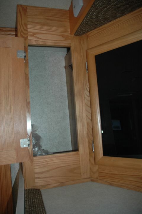 2005 Chevrolet C-6500/Kodiak - Interior view of wooden cabinetry with an open compartment.