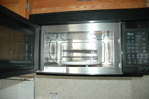 2005 Chevrolet C-6500/Kodiak - The interior of a microwave oven, showing the turntable and racks, with control panel visible on the right.