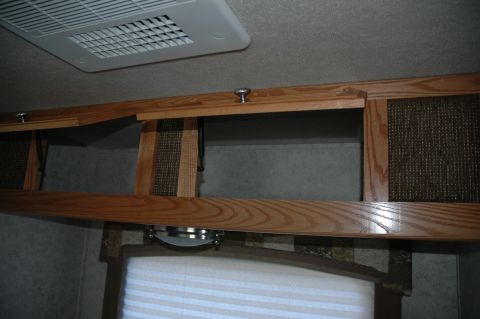 2005 Chevrolet C-6500/Kodiak - Overhead cabinets and air conditioner in an RV interior.