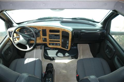 2005 Chevrolet C-6500/Kodiak - The interior of an RV shows the dashboard, steering wheel, and front seats.
