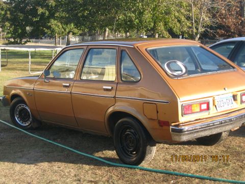1984 Chevrolet C/K Pickup - This brown hatchback car, likely from the early 1980s, is parked outdoors on a grassy area.