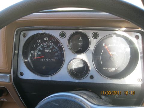 1984 Chevrolet C/K Pickup - The dashboard of a 1984 Chevrolet C/K Pickup shows the speedometer, fuel gauge, and temperature gauge.