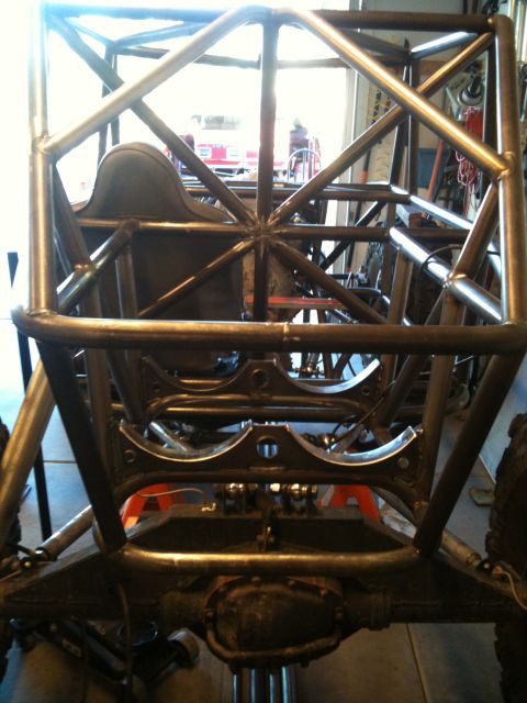 1966 Ford Bronco - This image shows the custom roll cage and seat of a buggy, with the rear axle visible.