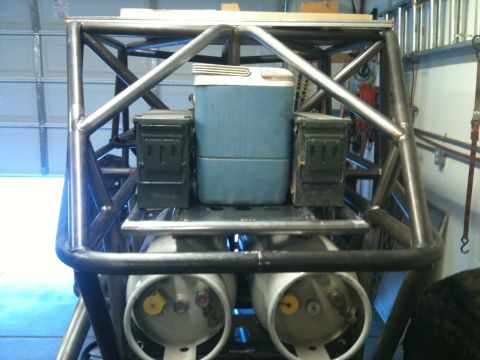 1966 Ford Bronco - This buggy's rear features a cooler, ammo cans, and two propane tanks mounted on a metal frame.