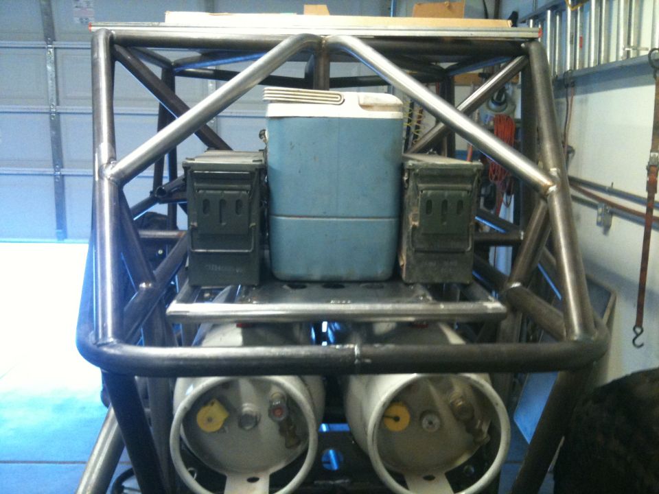 Rear view of off-road buggy with cooler, ammo cans, and propane tanks