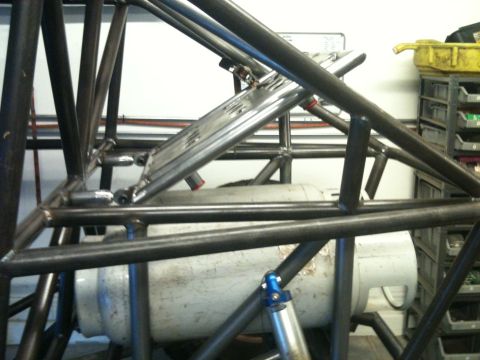 1966 Ford Bronco - The interior of a custom-built buggy shows a complex roll cage and a large white tank.