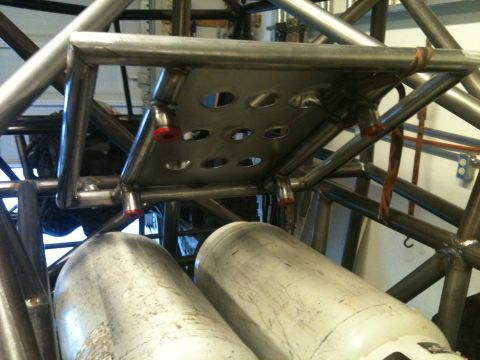 1966 Ford Bronco - Close-up view of a custom buggy's interior structure, showing fuel tanks and roll cage components.