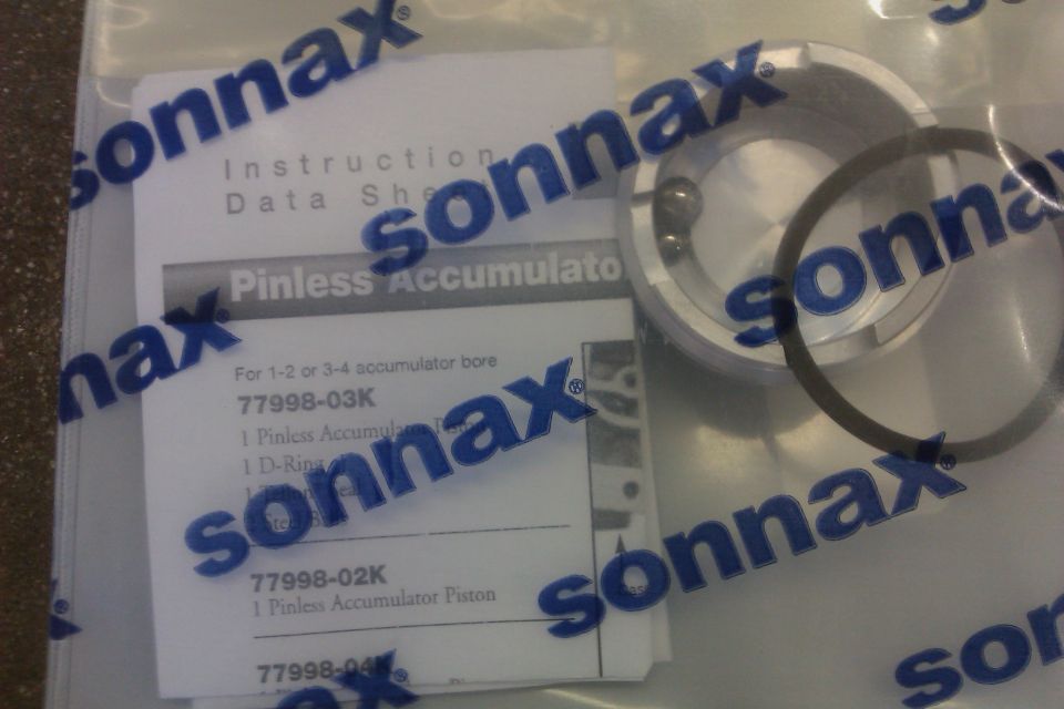Sonnax pinless accumulator kit with instruction sheet and parts