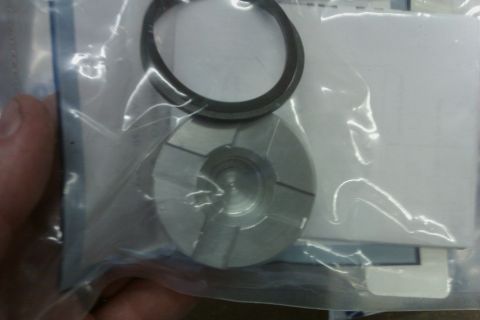 2005 GMC Yukon - A metal transmission part and a ring seal are shown inside plastic packaging.