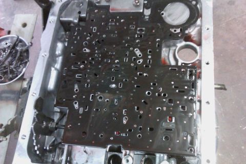 2005 GMC Yukon - Close-up of an automatic transmission valve body, likely undergoing repair or inspection.