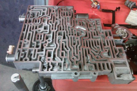 2005 GMC Yukon - This is a disassembled automatic transmission valve body, a critical component for gear shifting.