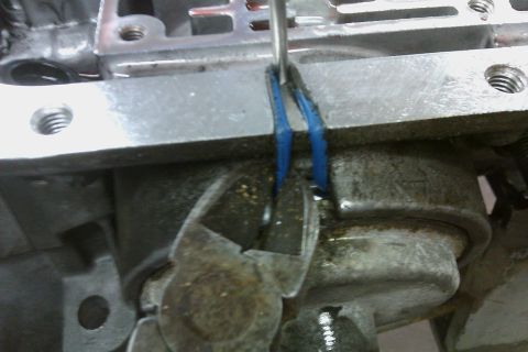 2005 GMC Yukon - Close-up of a transmission component being serviced with tools.