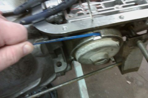 2005 GMC Yukon - Mechanic uses a blue tool to work on a transmission component during a rebuild.